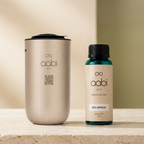 Aabi Car Diffuser in gold with Sea Breeze aroma oil 170ml on cream stone