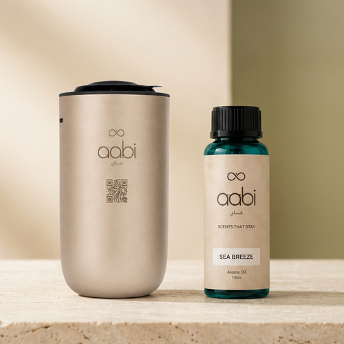Aabi Car Diffuser in gold with Sea Breeze aroma oil 170ml on cream stone